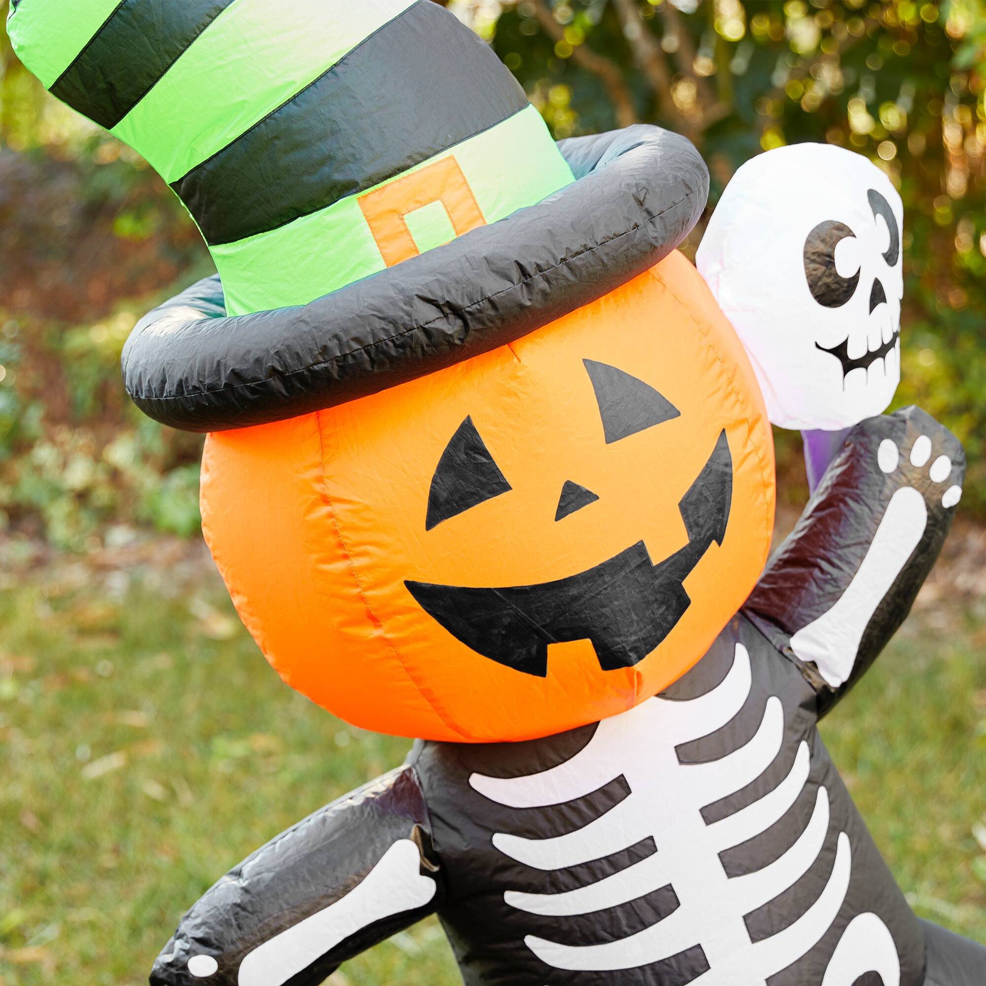 Glitzhome® 6ft. Lighted Halloween Jack-O'-Lantern Skeleton Rotating Inflatable Décor